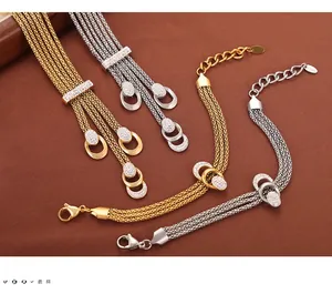 Detailed macro view of layered steel chains with rhinestone-encrusted oval pendants