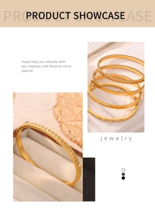Detailed close-up of gold-plated titanium bangles with assorted textures and crystal inlay