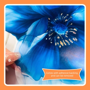 Detail of blue floral wall sticker showing transparent material and adhesive backing