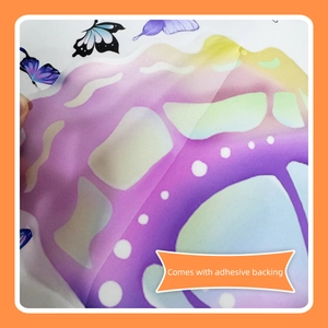 Close-up showing the adhesive backing and gradient butterfly wall sticker peel-off process