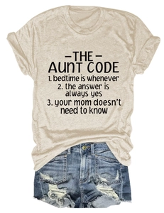 Detail of beige round neck T-shirt with The Aunt Code slogan and distressed denim shorts