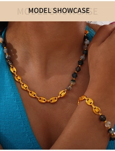 Detail of 18K gold-plated beaded necklace and bracelet set with natural stone accents