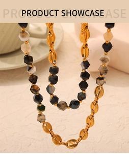 Detail of 18K gold-plated links and faceted natural stone beads on a layered necklace