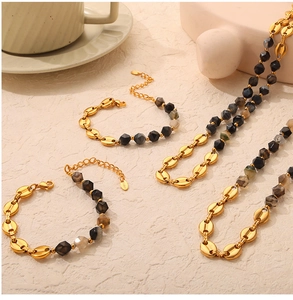 Detail of 18K gold coffee bean link chain with faceted natural stone beads and lobster clasp