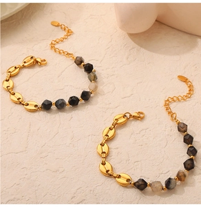Detailed view of handmade beaded 18K gold plated bracelets with natural dark gemstones