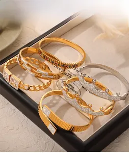 Dettaglio di bracciali a corona in oro con zirconi su un vassoio per gioielli in velluto