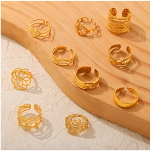 Detail of 10-piece gold stainless steel rings set featuring hollow heart and floral designs