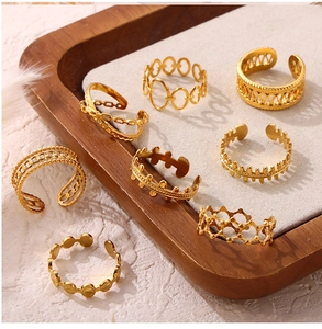 Set of eight gold-plated titanium steel rings featuring hollow geometric and chain designs
