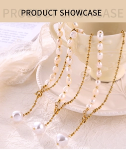 Detail of freshwater baroque pearl pendants on 18K gold plated titanium steel necklaces