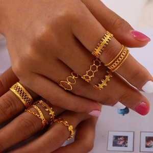Stackable gold-plated titanium rings with hollow geometric designs and vintage accents