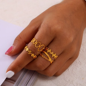 Set of four hollow gold-plated titanium steel rings featuring unique cutout and chain designs