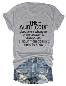 Close-up of The Aunt Code slogan print on gray crew neck t-shirt with denim shorts