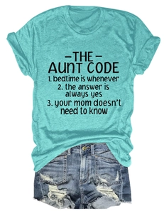 Detailed look at the aunt code print on a green tee and distressed denim shorts