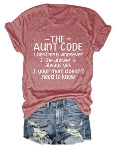 Close-up of brick red crew neck t-shirt with slogan and ripped denim shorts outfit