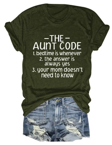 Flat lay of Army Green t-shirt with Aunt Code print and distressed blue denim shorts
