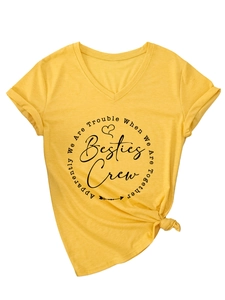 Detail of yellow V-neck T-shirt showing Besties Crew print and front hem knot design