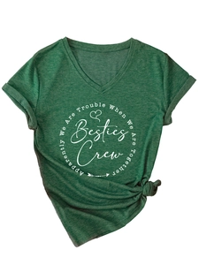 Detail of V-neck dark green T-shirt with Besties Crew print and side knot hem styling