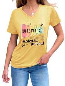Detail of yellow V-neck T-shirt with xylophone print and Do Re Mi Fa So excited text