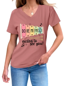 Detail of pink V-neck T-shirt featuring a colorful xylophone print and musical notes