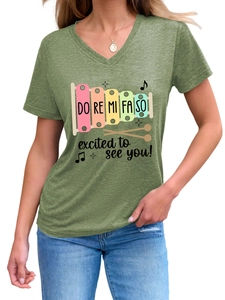 Detail of V-neck heather green T-shirt with colorful xylophone print and music slogan
