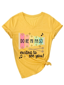 Detail of yellow V-neck T-shirt with rainbow xylophone print and funny musical slogan