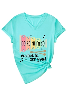 Detail of mint green V-neck T-shirt with xylophone print and tied front hem detail