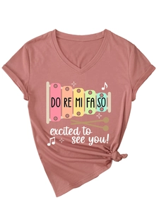 Detail of V-neck T-shirt in brick red with musical notes and excited to see you slogan