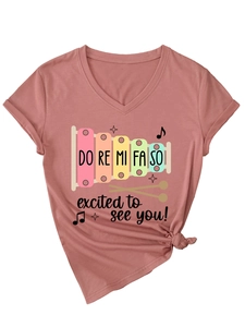 Detail of V-neck T-shirt in dusty rose with musical xylophone print and waist knot design