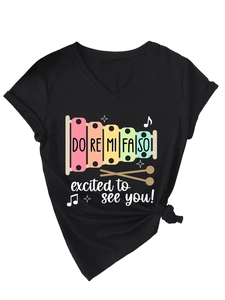 Detail of V-neck cotton T-shirt featuring colorful xylophone print and music slogan
