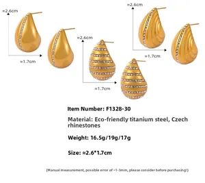 Detailed view of three gold teardrop earrings set in stainless steel with crystal accents