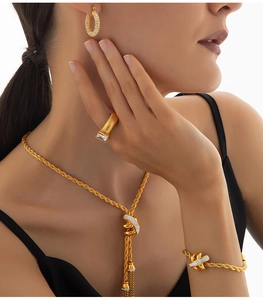 Close-up of golden rope chain jewelry set with sparkling pavé cubic zirconia details
