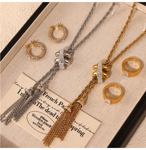 Detail of twisted rope chain jewelry set with crystal tassels on a display tray