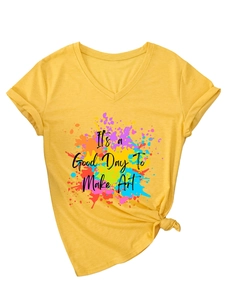 Detail of V-neck yellow t-shirt featuring artistic art print and trendy knotted hem