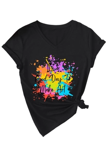 Detail of V-neck black T-shirt featuring colorful ink splash and Art slogan with side knot