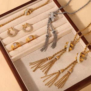 Luxe twisted rope necklaces and gold rings with zircon earrings in a jewelry tray