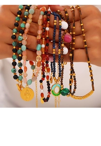Close-up of mixed natural stone beaded necklaces with gold pendants and colorful charms