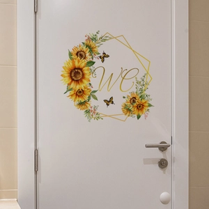 Macro view of sunflower wreath door sticker with gold WC text and butterfly accents