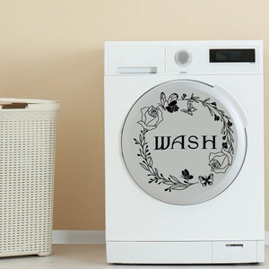 Detail of floral butterfly decal with WASH lettering on a front-load washing machine door