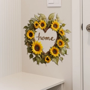 Heart-shaped sunflower wreath with Home lettering hanging on a clean living room wall