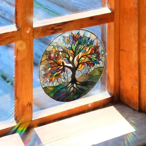 Close-up of circular tree of life static window film showing colorful sunlit glass effects
