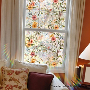 Detailed close-up of bird and floral pattern static window film with rainbow light effect