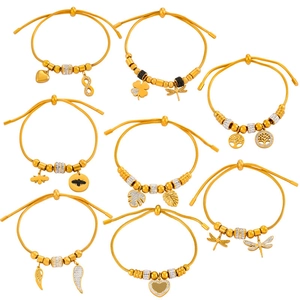 Set of 8 gold titanium bracelets featuring heart, clover, and bee charms with crystal accents