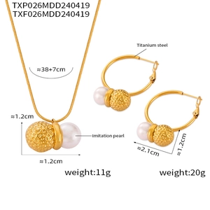 Detail of gold titanium steel jewelry set featuring hammered beads and white imitation pearls