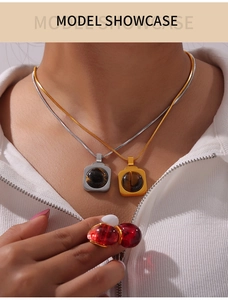 Gros plan d'un collier à deux rangs avec pendentif oeil de tigre doré et argenté sur modèle