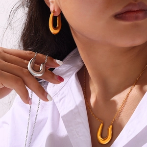Minimalist U-shaped 18k gold plated jewelry set featuring necklace, earrings and ring
