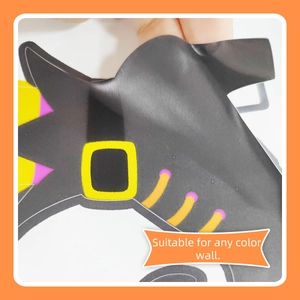 Detail of self-adhesive Halloween witch hat wall sticker being peeled for easy application
