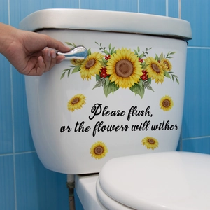 Détail du sticker tournesol avec texte sur un fond de carrelage bleu de salle de bain