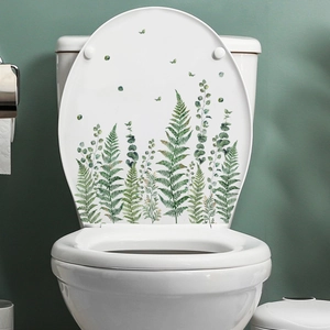 Détail des stickers de feuilles de fougère à l'aquarelle sur un couvercle de toilette