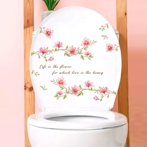 Sticker floral avec magnolias roses et citation sur un abattant de WC blanc