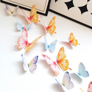 Macro view of 3D butterfly wall stickers with gold edges and watercolor gradient textures